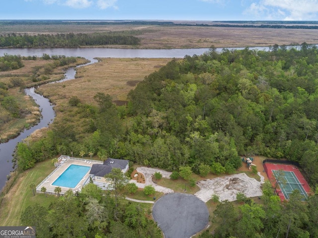 bird's eye view featuring a forest view and a water view