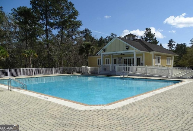 pool featuring a patio, a ceiling fan, and fence