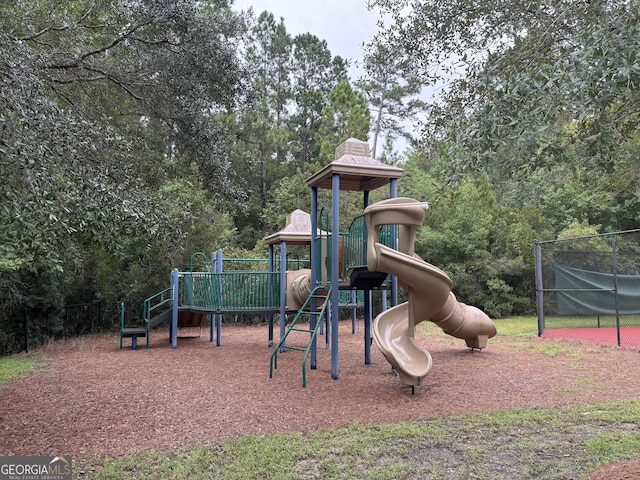 community jungle gym featuring a wooded view