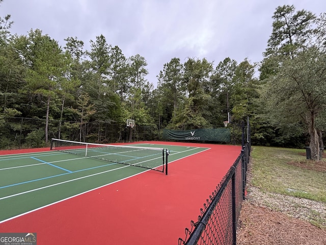 view of tennis court featuring fence