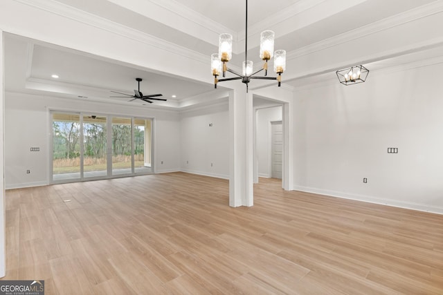 unfurnished living room featuring ornamental molding, a raised ceiling, baseboards, and light wood finished floors