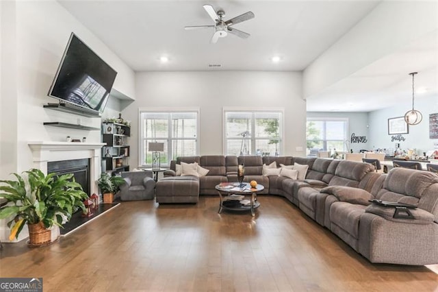 living room featuring hardwood / wood-style flooring and ceiling fan