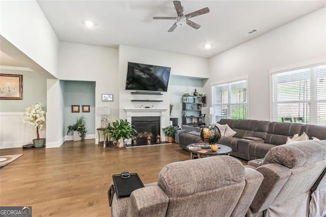 living room featuring ceiling fan and wood-type flooring