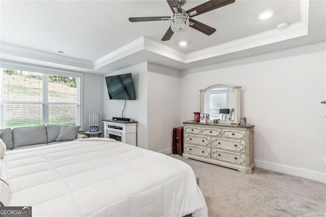 bedroom with carpet, ceiling fan, a raised ceiling, and ornamental molding