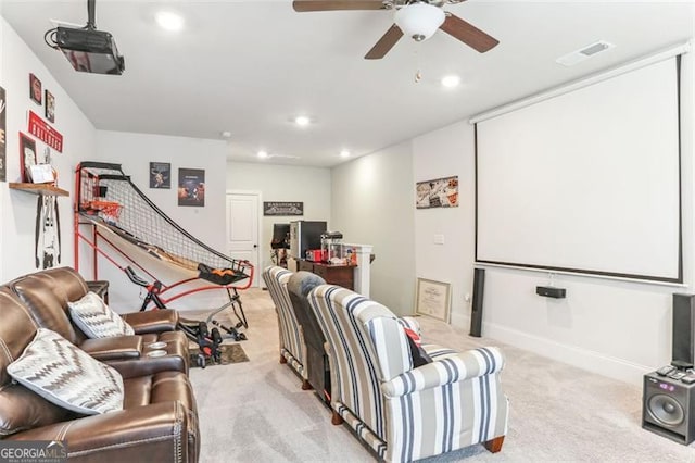 carpeted home theater room featuring ceiling fan