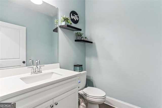 bathroom featuring vanity and toilet