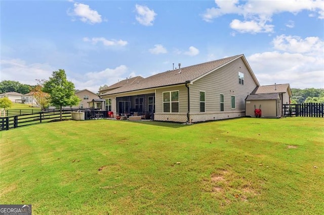 rear view of house featuring a yard