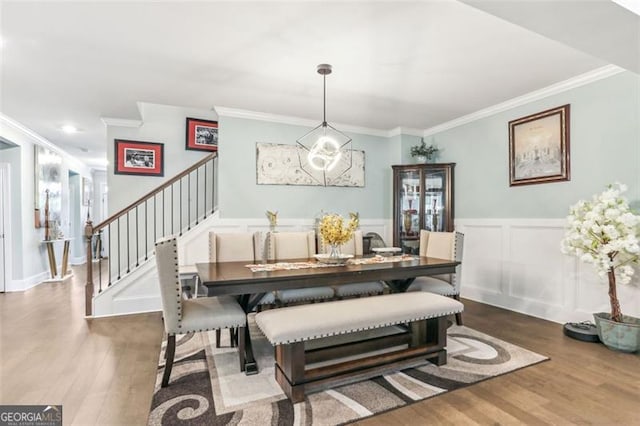 dining area featuring crown molding and hardwood / wood-style flooring