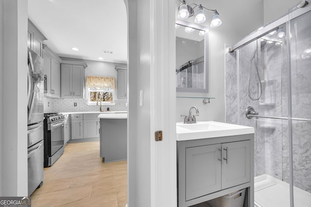 bathroom featuring backsplash, walk in shower, and vanity