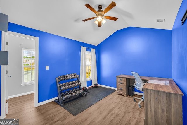 office featuring ceiling fan, plenty of natural light, vaulted ceiling, and light wood-type flooring