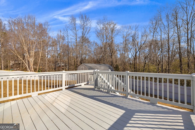 wooden deck featuring a storage unit