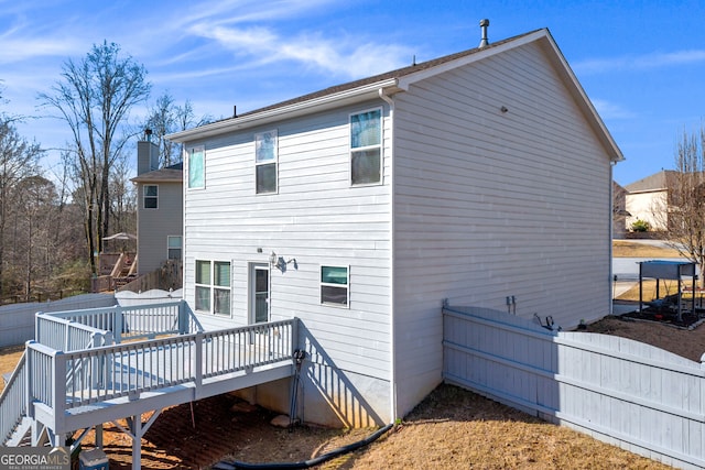 rear view of property with a wooden deck