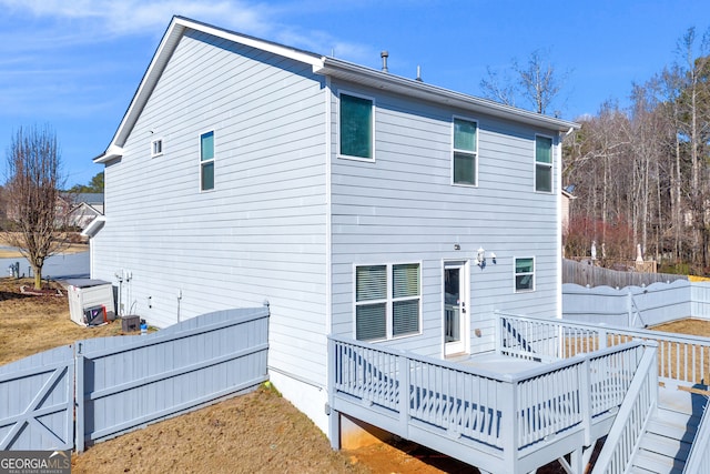 rear view of house with a wooden deck