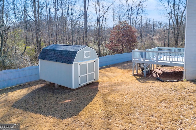 view of yard featuring a deck and a shed