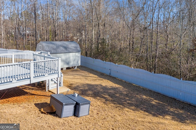 view of yard with a deck and a shed