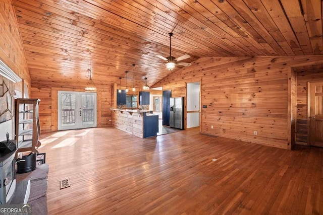 unfurnished living room with ceiling fan, hardwood / wood-style floors, wood ceiling, and lofted ceiling