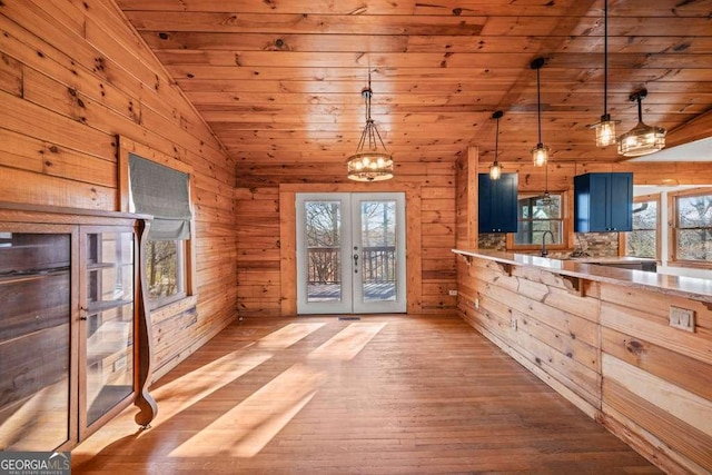 kitchen featuring pendant lighting, lofted ceiling, french doors, blue cabinetry, and wood ceiling