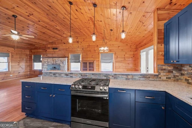 kitchen with blue cabinets, hanging light fixtures, and stainless steel gas range