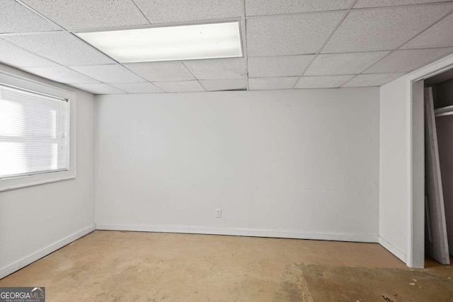 basement with a paneled ceiling