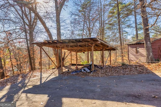 exterior space featuring a shed and a carport