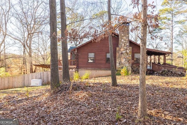 view of side of home with a wooden deck