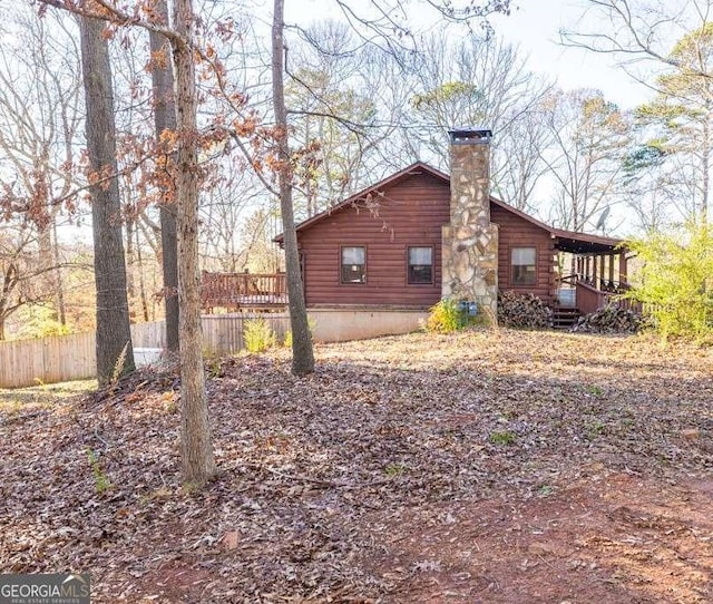 view of property exterior with a deck