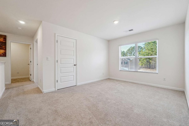 unfurnished bedroom with light colored carpet