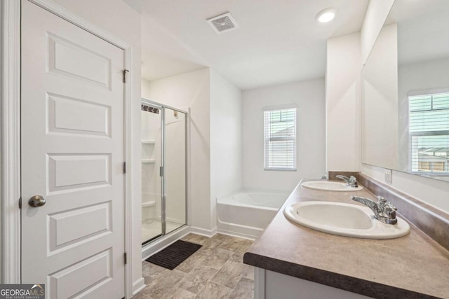 bathroom with vanity and independent shower and bath