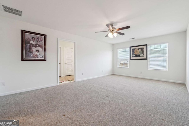 empty room with carpet floors and ceiling fan