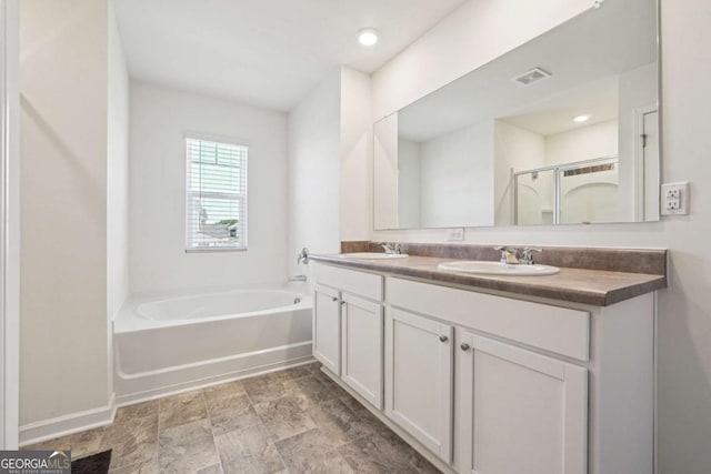 bathroom with vanity and independent shower and bath