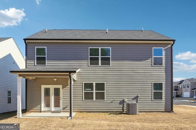 rear view of property featuring a patio area and central air condition unit