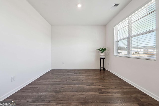 unfurnished room with dark hardwood / wood-style floors