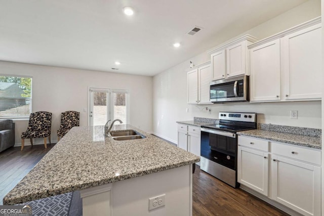 kitchen featuring appliances with stainless steel finishes, an island with sink, white cabinetry, and sink