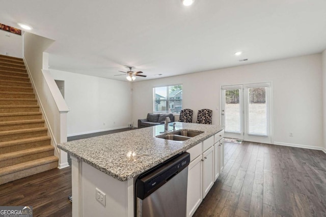 kitchen featuring dishwasher, a kitchen island with sink, sink, ceiling fan, and white cabinetry