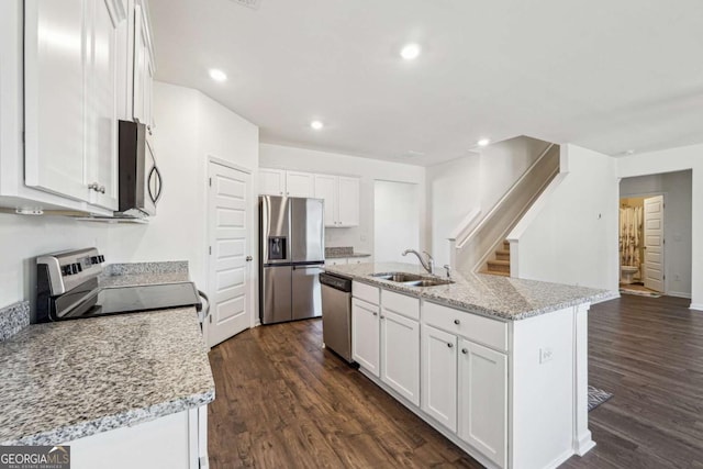 kitchen featuring white cabinets, stainless steel appliances, and sink