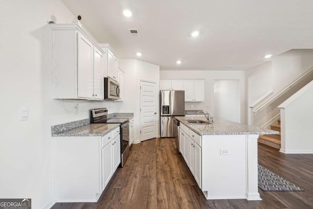 kitchen featuring a center island with sink, white cabinets, sink, dark hardwood / wood-style flooring, and stainless steel appliances