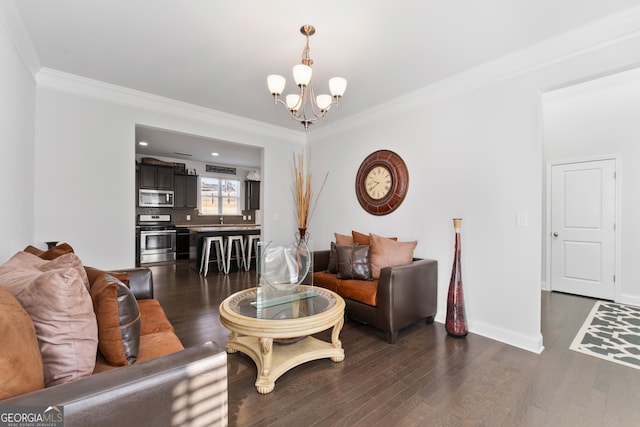 living room with a chandelier, dark wood-type flooring, and crown molding