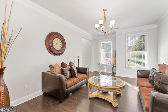 living room with dark hardwood / wood-style flooring, ornamental molding, and a notable chandelier