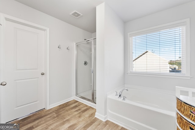 bathroom featuring hardwood / wood-style floors, vanity, and separate shower and tub