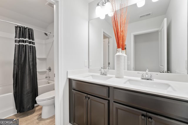 full bathroom featuring shower / bath combo, vanity, hardwood / wood-style flooring, and toilet