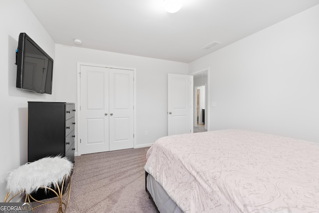 bedroom featuring carpet and a closet