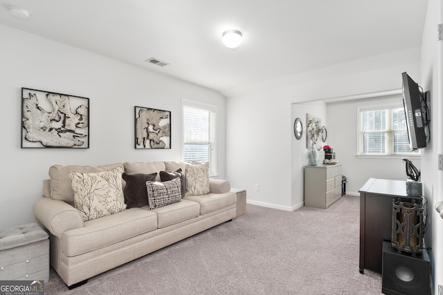 living room with light colored carpet and a wealth of natural light