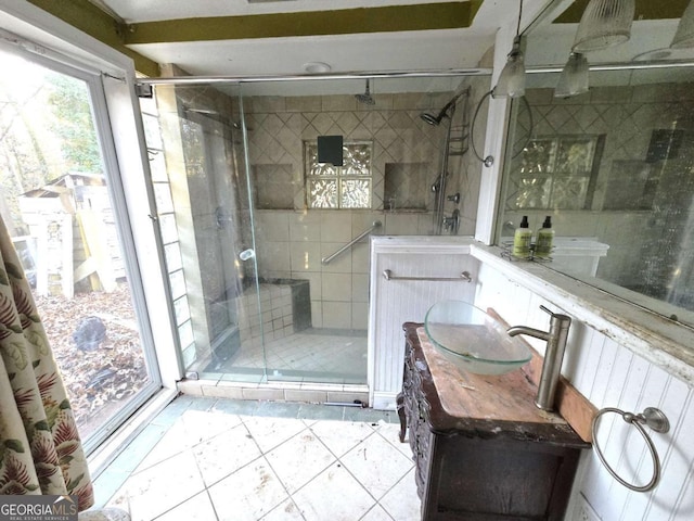 bathroom with vanity and a shower with door