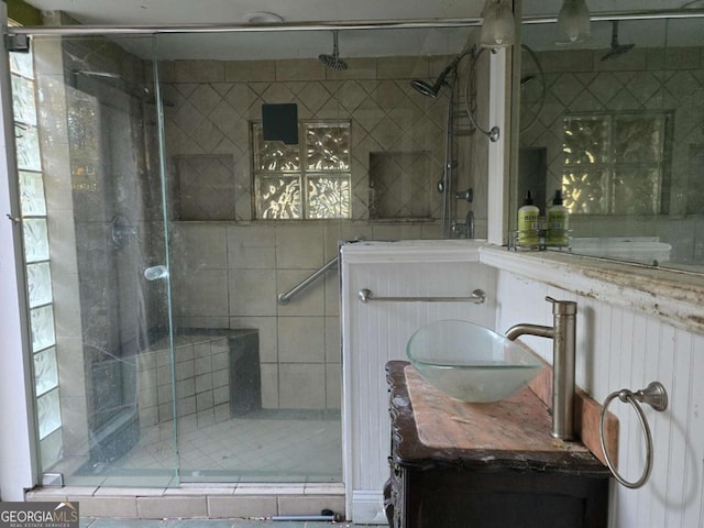 bathroom featuring vanity and an enclosed shower