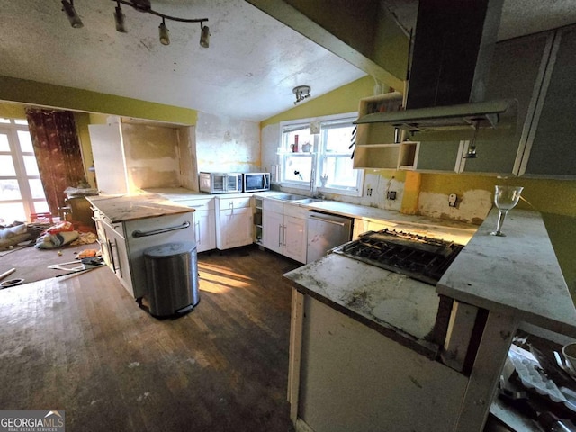 kitchen featuring sink, extractor fan, lofted ceiling, white cabinets, and appliances with stainless steel finishes