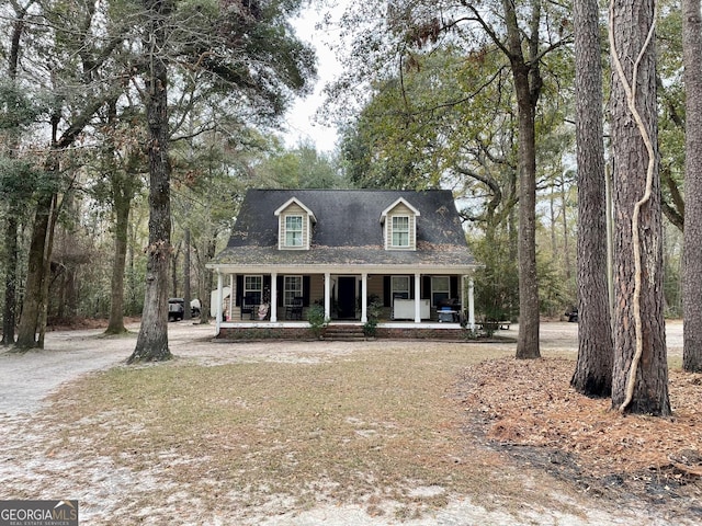 new england style home featuring covered porch