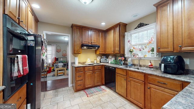 kitchen featuring light tile patterned floors, sink, and black appliances