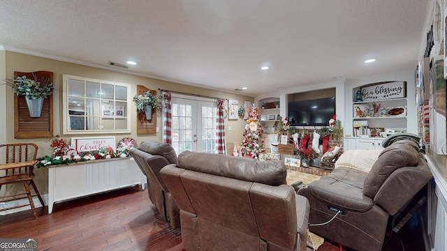 living room featuring french doors, dark wood-type flooring, built in features, crown molding, and a textured ceiling