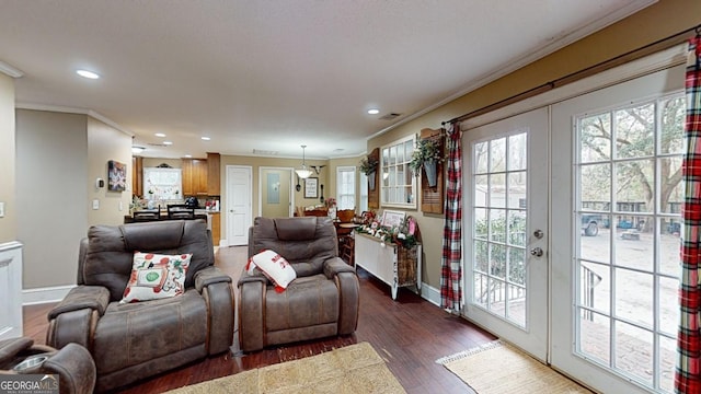 living room featuring french doors, dark wood-type flooring, and ornamental molding