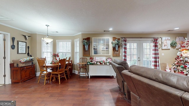 dining area featuring a wealth of natural light, dark hardwood / wood-style flooring, crown molding, and french doors